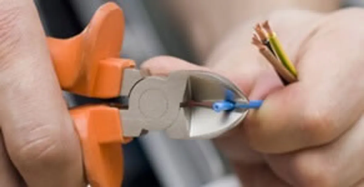 professional electrical services showing precise wire cutting by licensed electricians in St Paul, MN